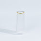 Clear stemless plastic champagne flute with gold rim.