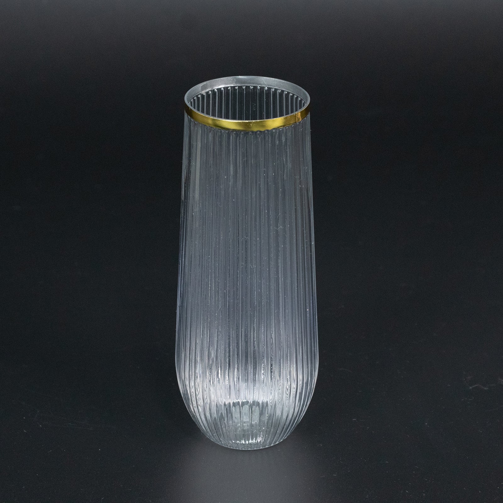 Clear ribbed plastic champagne flute with gold rim.