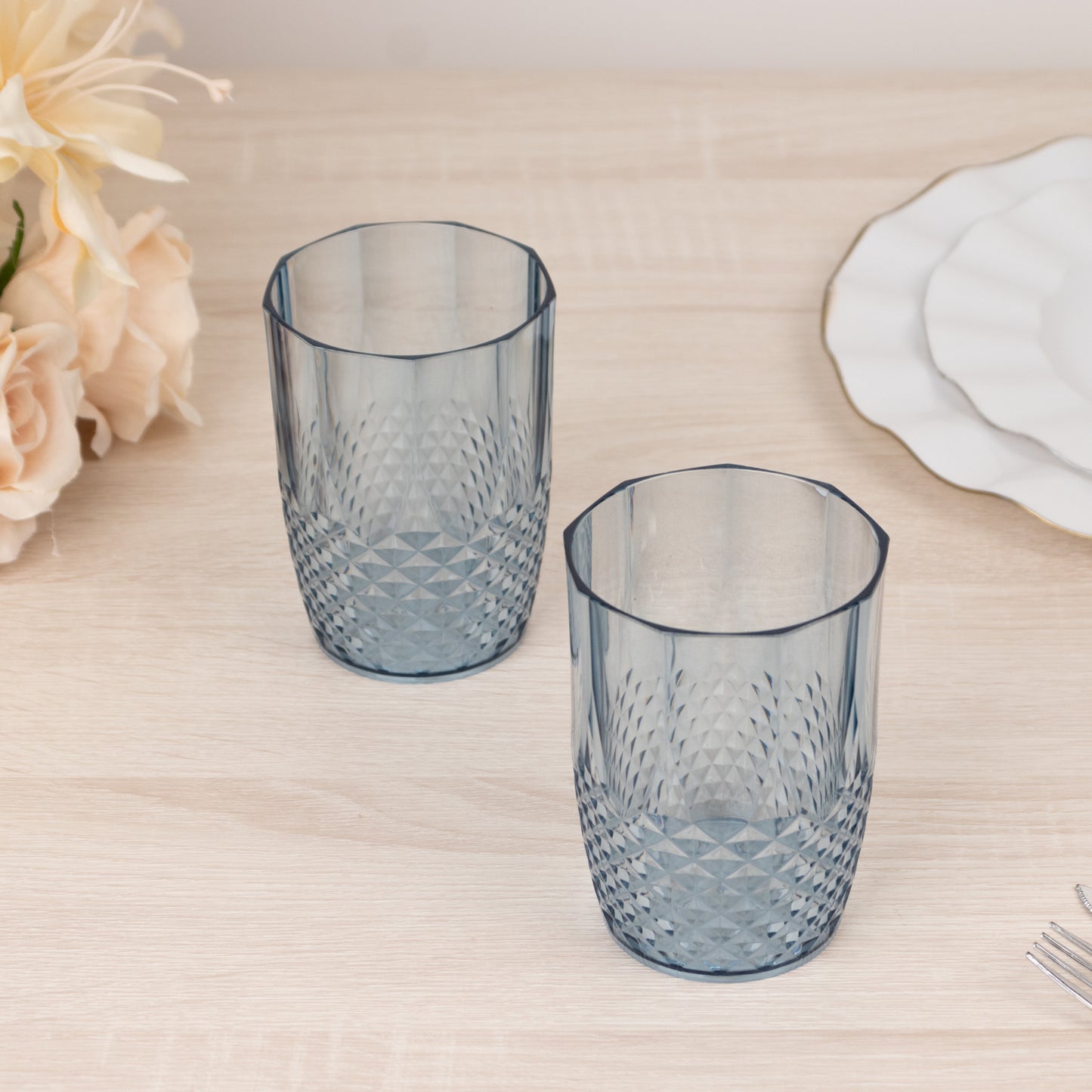 Dusty blue reusable plastic tumbler glasses in crystal cut style.