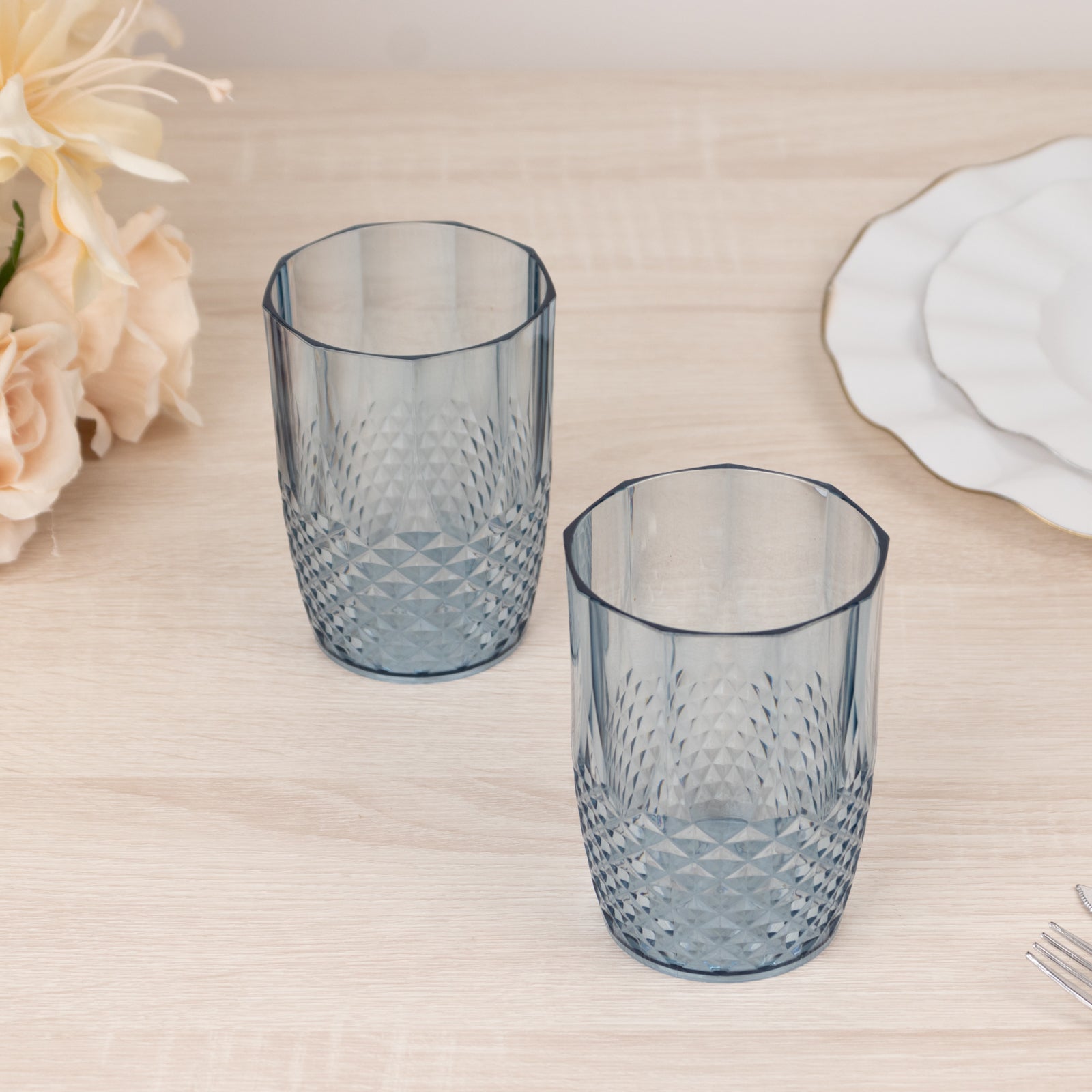Dusty blue reusable plastic tumbler glasses in crystal cut style.