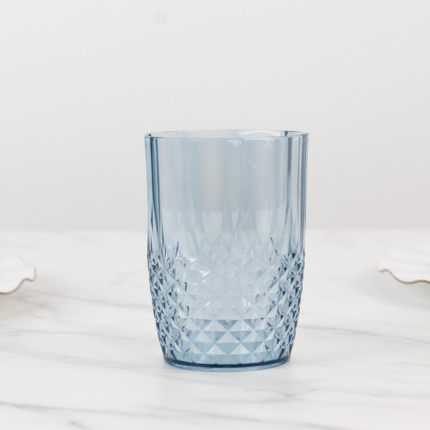 Dusty blue reusable plastic tumbler glass in crystal cut style.