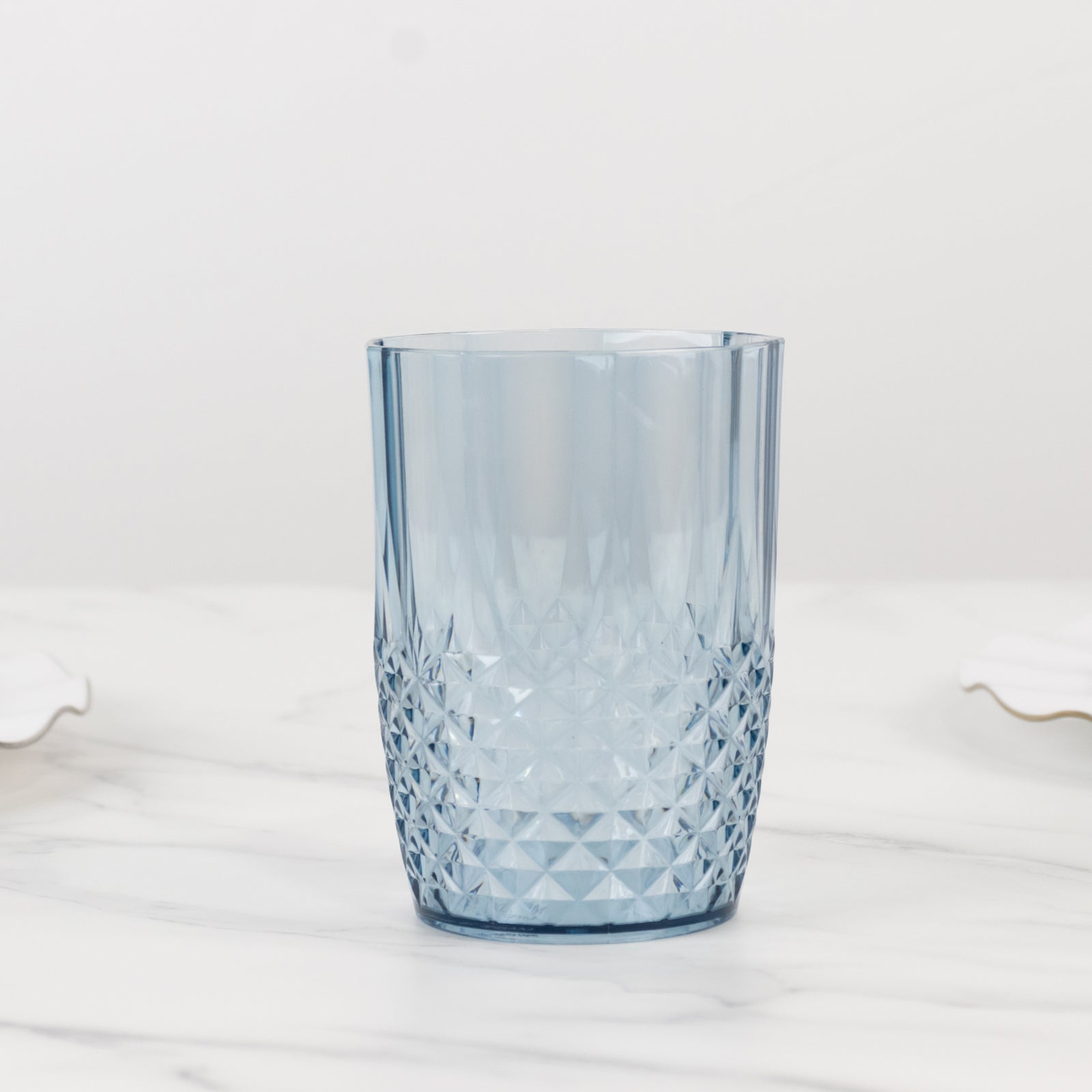 Dusty blue reusable plastic tumbler glass in crystal cut style.