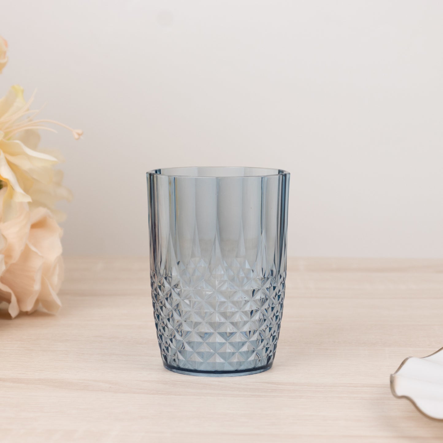 Dusty blue reusable plastic tumbler glass in crystal cut style.