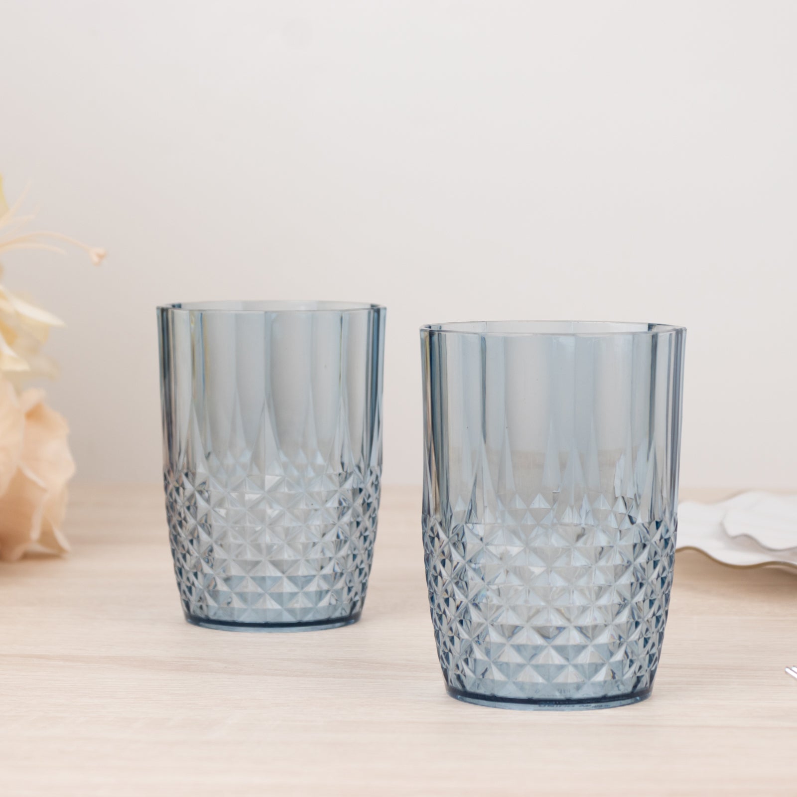 Dusty blue reusable plastic tumbler glasses in crystal cut style.