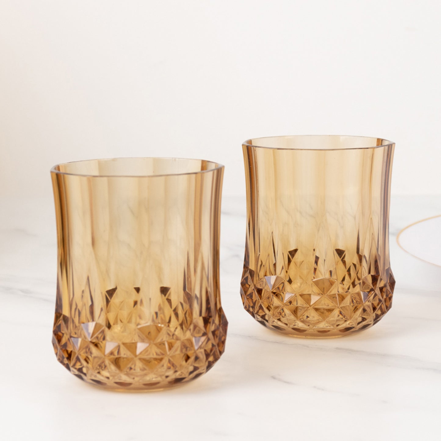 Amber gold crystal cut stemless wine glasses, shatterproof and reusable.