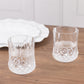 Clear crystal cut plastic stemless wine glasses on a wooden table.