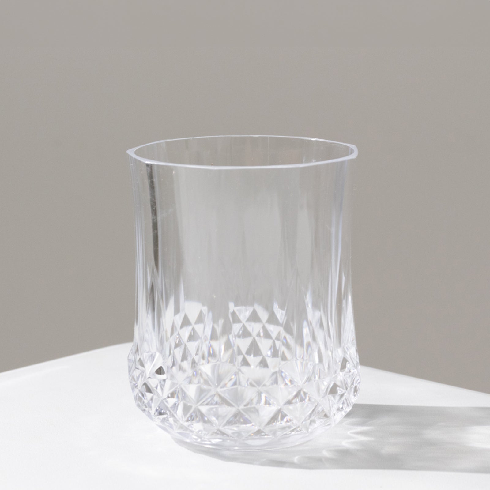 Clear crystal cut plastic stemless wine glass, shatterproof and reusable.