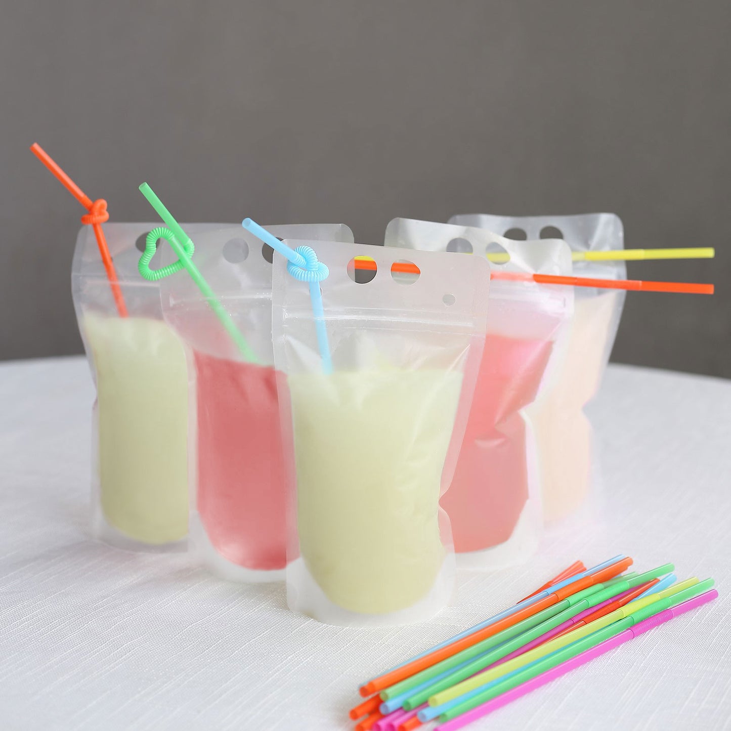50 Pack Translucent Stand-Up Plastic Smoothie Drink Bags with Straws, 12oz Reusable Hand-Held Zipper Juice Pouches