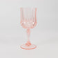 Transparent blush crystal cut reusable plastic cocktail goblet.