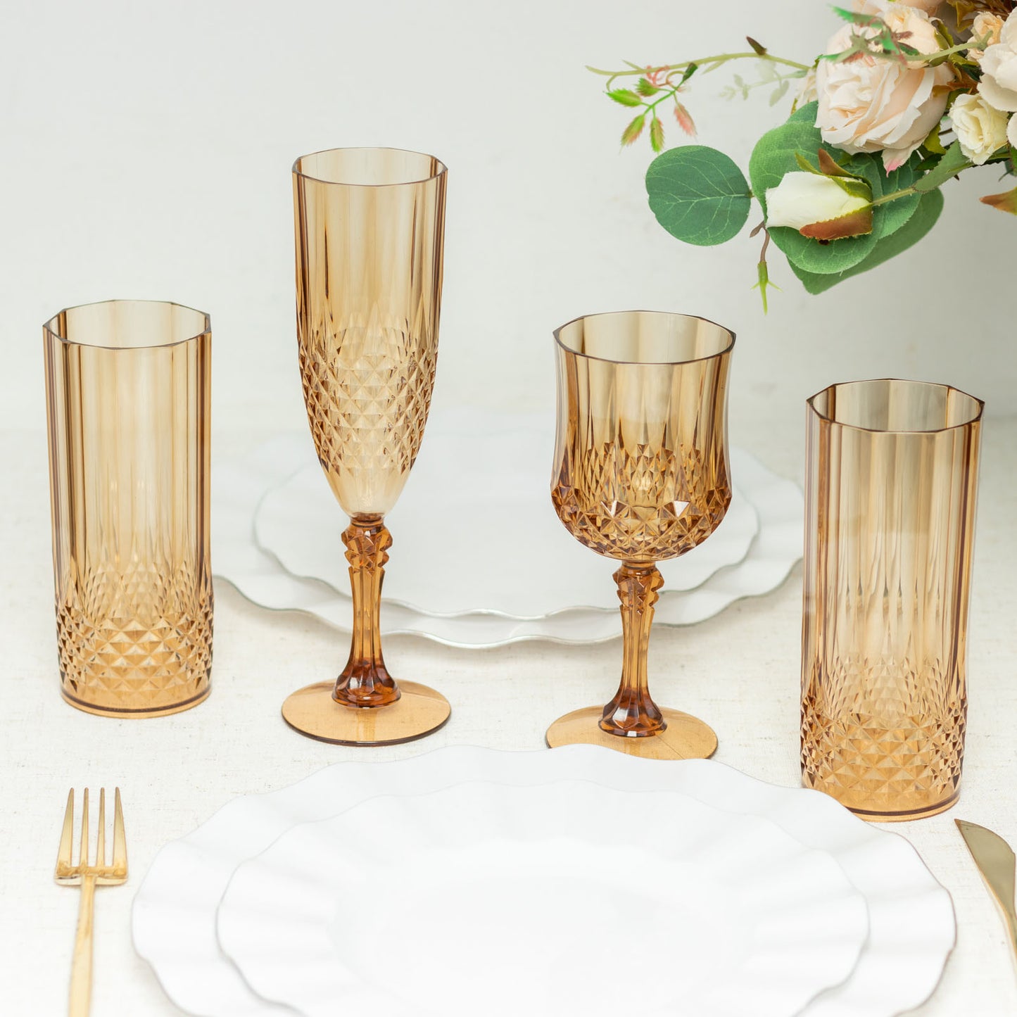 Amber gold reusable plastic cocktail goblets on a table setting.
