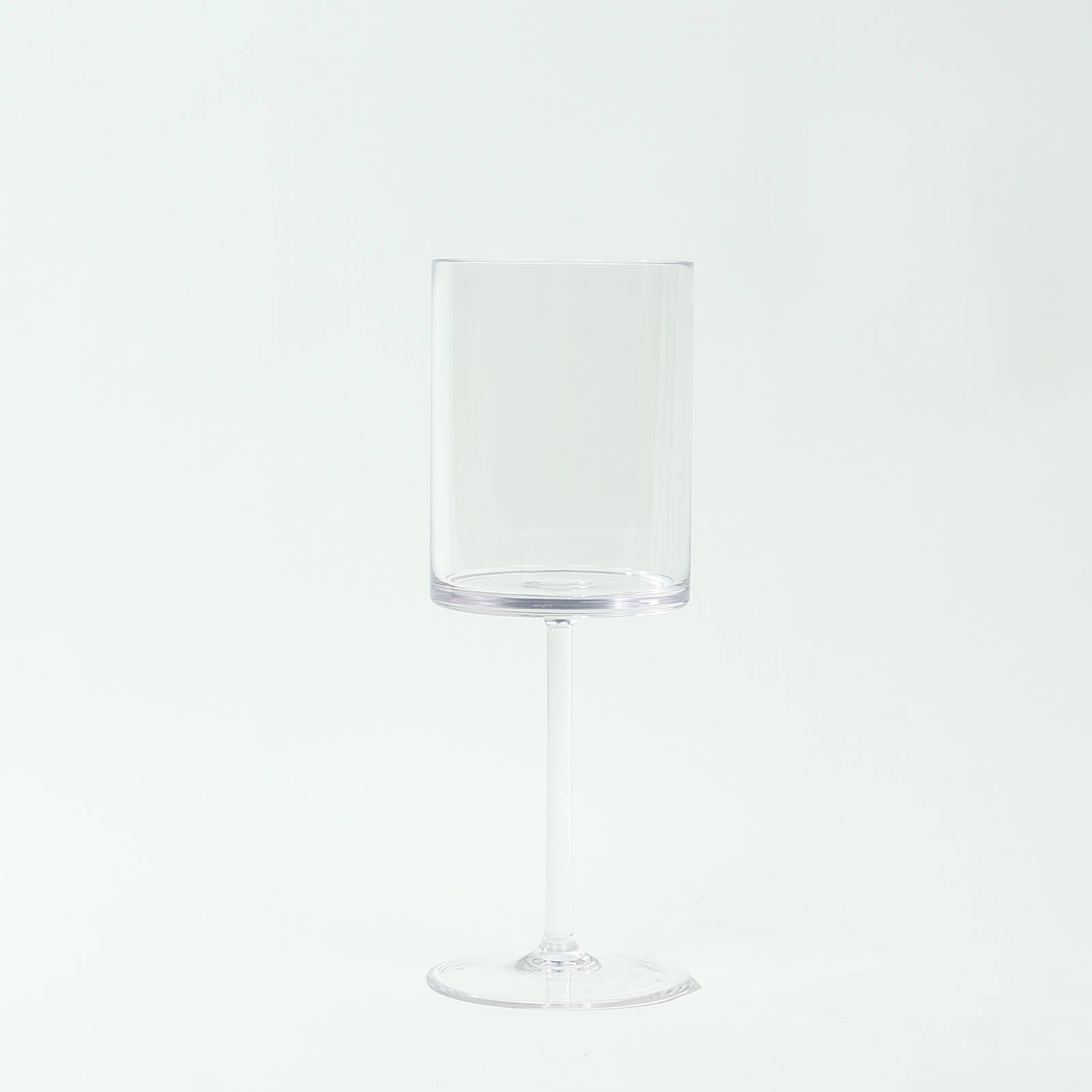 Clear plastic reusable cocktail glass with long stem, shatterproof design.