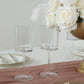 Clear plastic reusable cocktail glasses on a table setting.