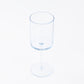 Transparent dusty blue reusable cocktail glass with long stem.