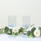Transparent dusty blue reusable cocktail glasses with long stems.