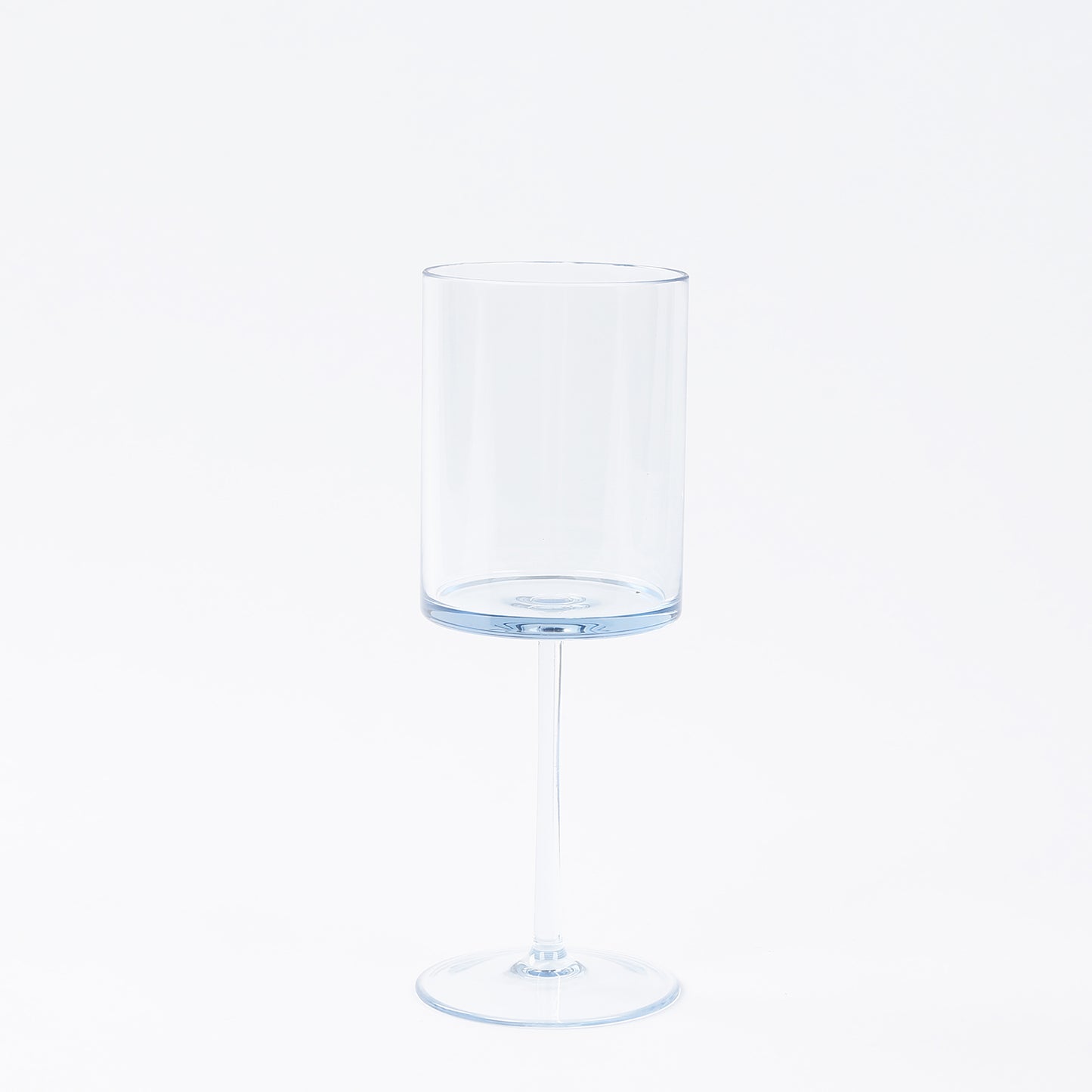 Transparent dusty blue reusable cocktail glass with long stem.