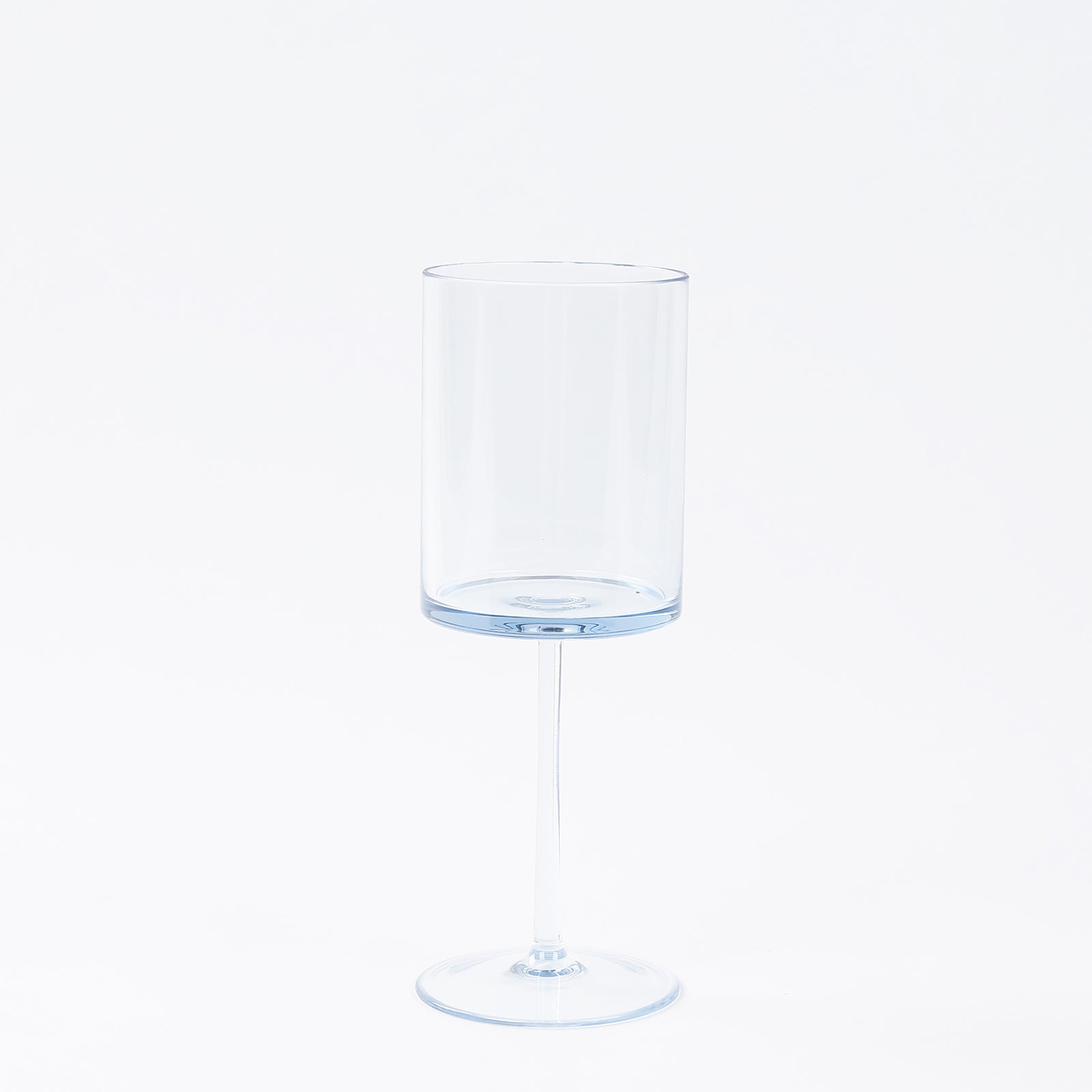 Transparent dusty blue reusable cocktail glass with long stem.