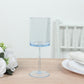 Transparent dusty blue reusable cocktail glass with long stem.