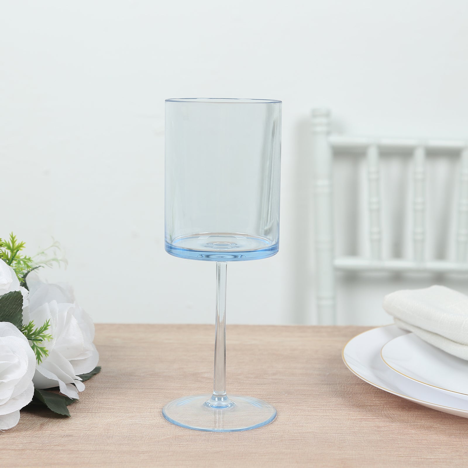 Transparent dusty blue reusable cocktail glass with long stem.