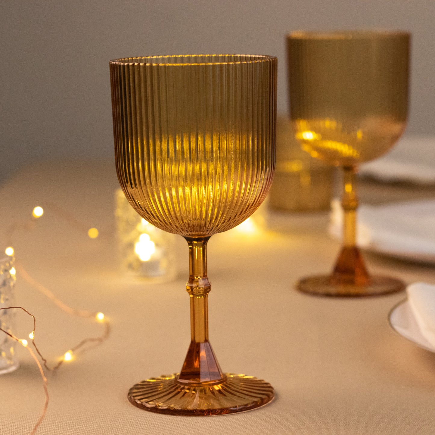 Amber gold ribbed reusable plastic wine goblets, shatterproof vintage design.