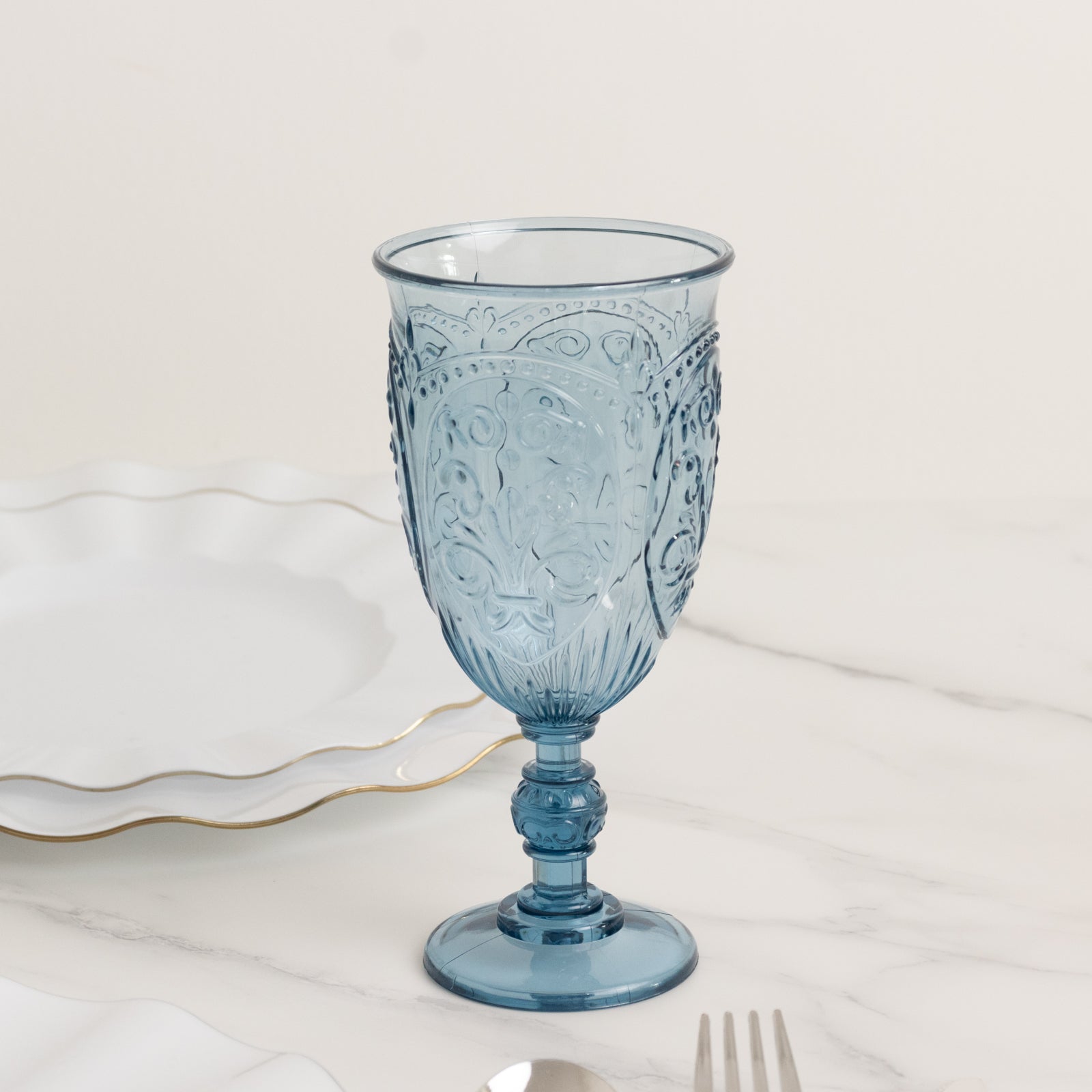 Transparent dusty blue vintage goblet with retro embossed design.