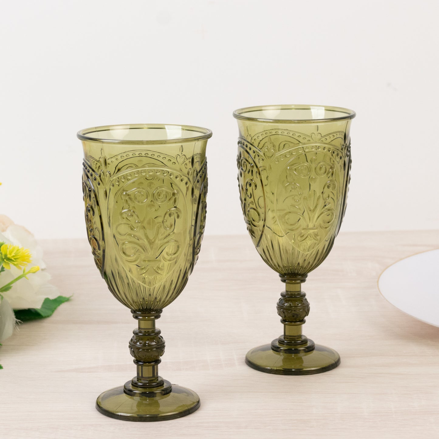 Transparent dusty sage green vintage wine glasses with embossed design.