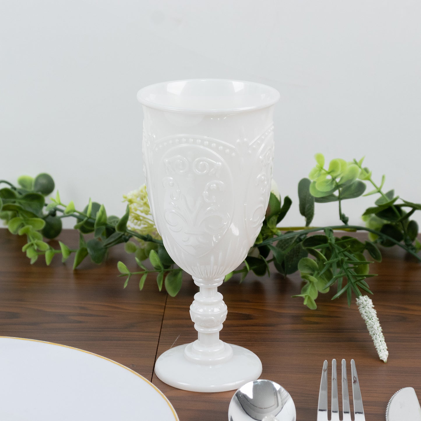 Pearl white vintage goblet with retro embossed design, elegant drinkware.