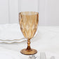 Amber gold vintage diamond cut plastic goblet on a marble surface.