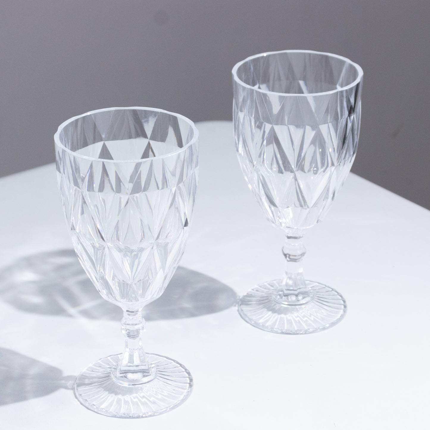 Clear vintage diamond cut plastic goblets for wine and beverages.