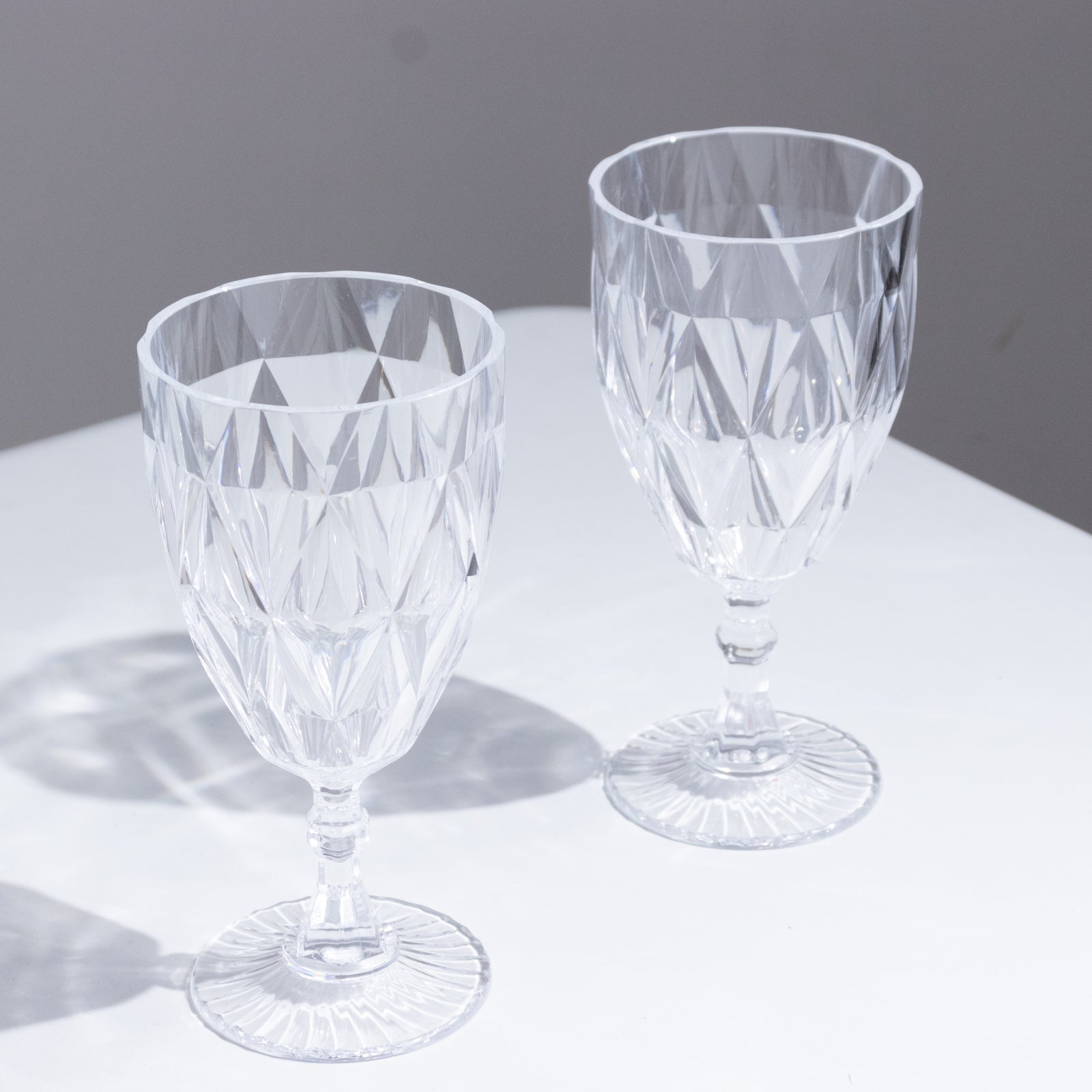 Clear vintage diamond cut plastic goblets for wine and beverages.