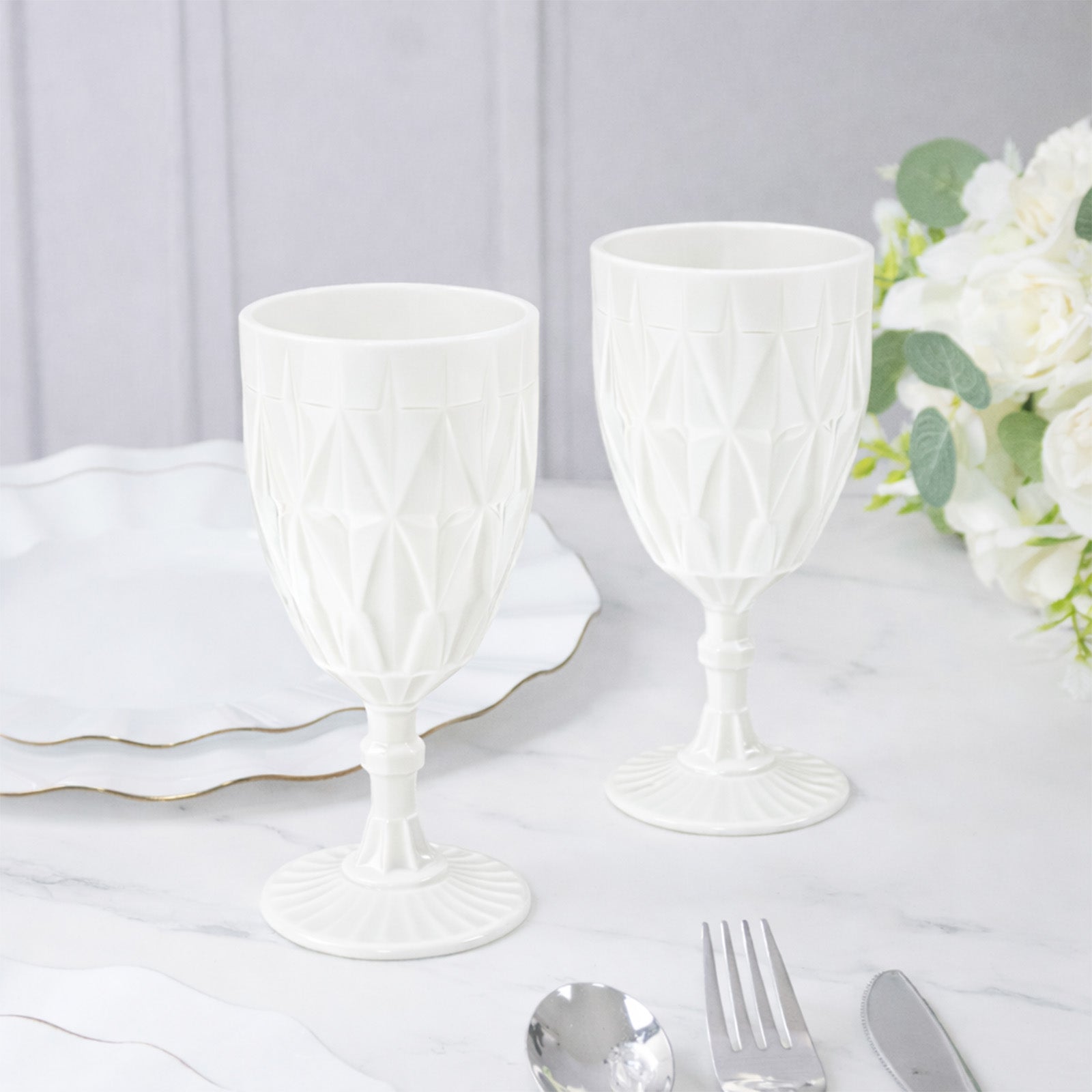 Pearl white vintage diamond cut plastic goblets on a table setting.