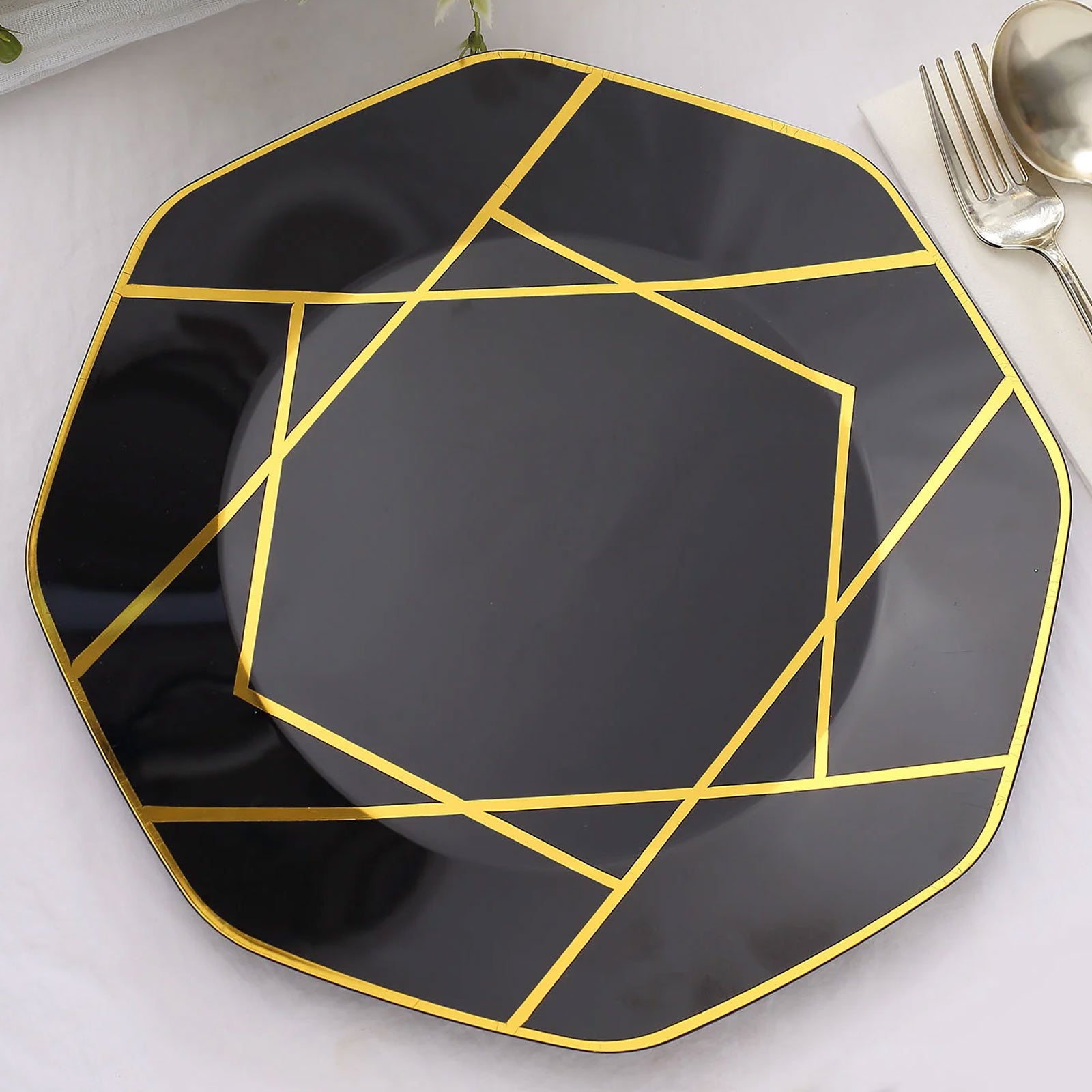 Black and gold geometric design disposable dinner plate.