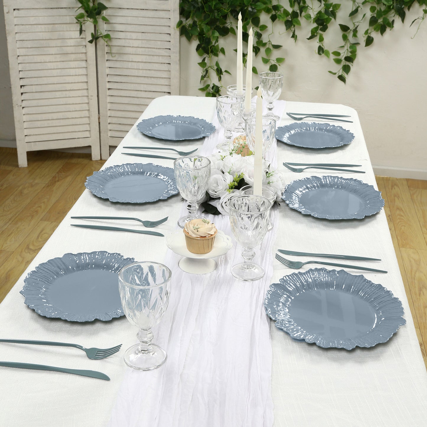 Dusty blue reef design disposable dinner plates on a table setting.