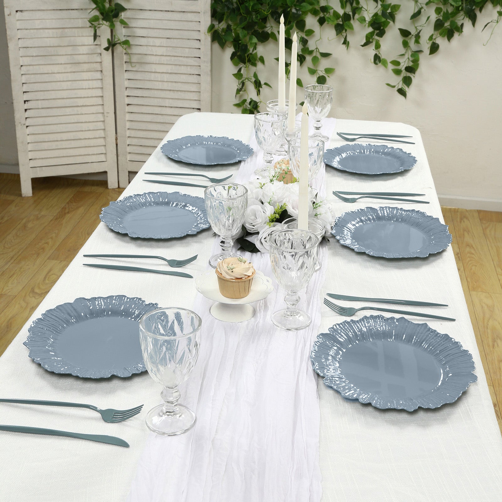 Dusty blue reef design disposable dinner plates on a table setting.
