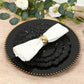 Black dinner plate with elegant reef design and a napkin.