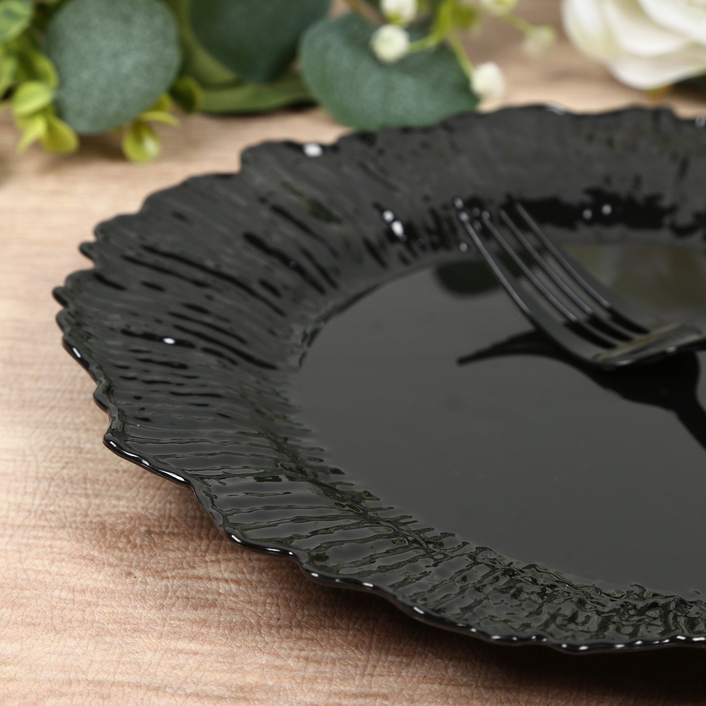 Black plastic dinner plate with elegant reef design.