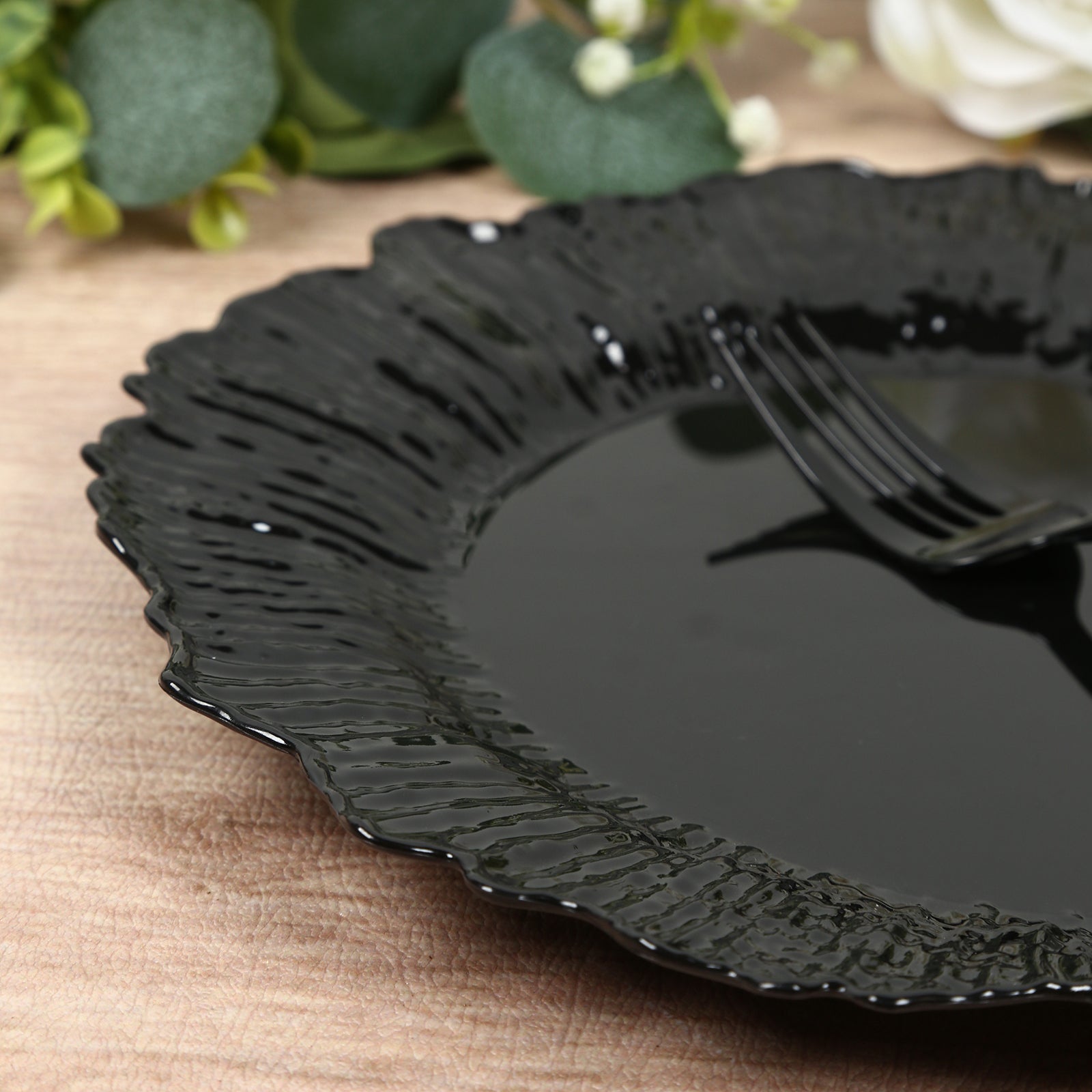 Black plastic dinner plate with elegant reef design.