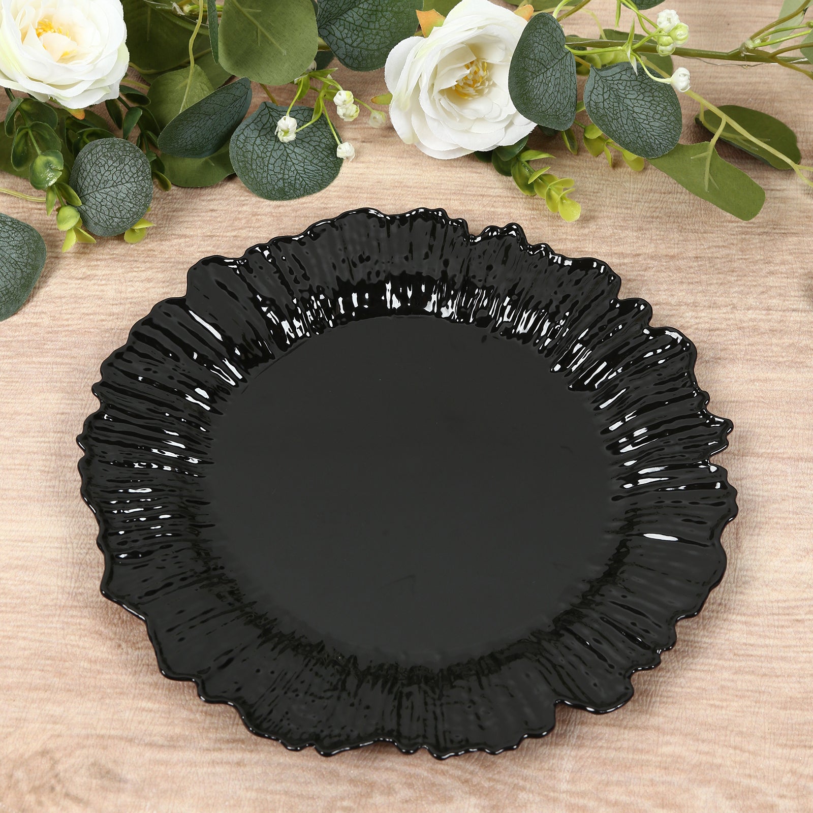 Black plastic dinner plate with an elegant reef design.