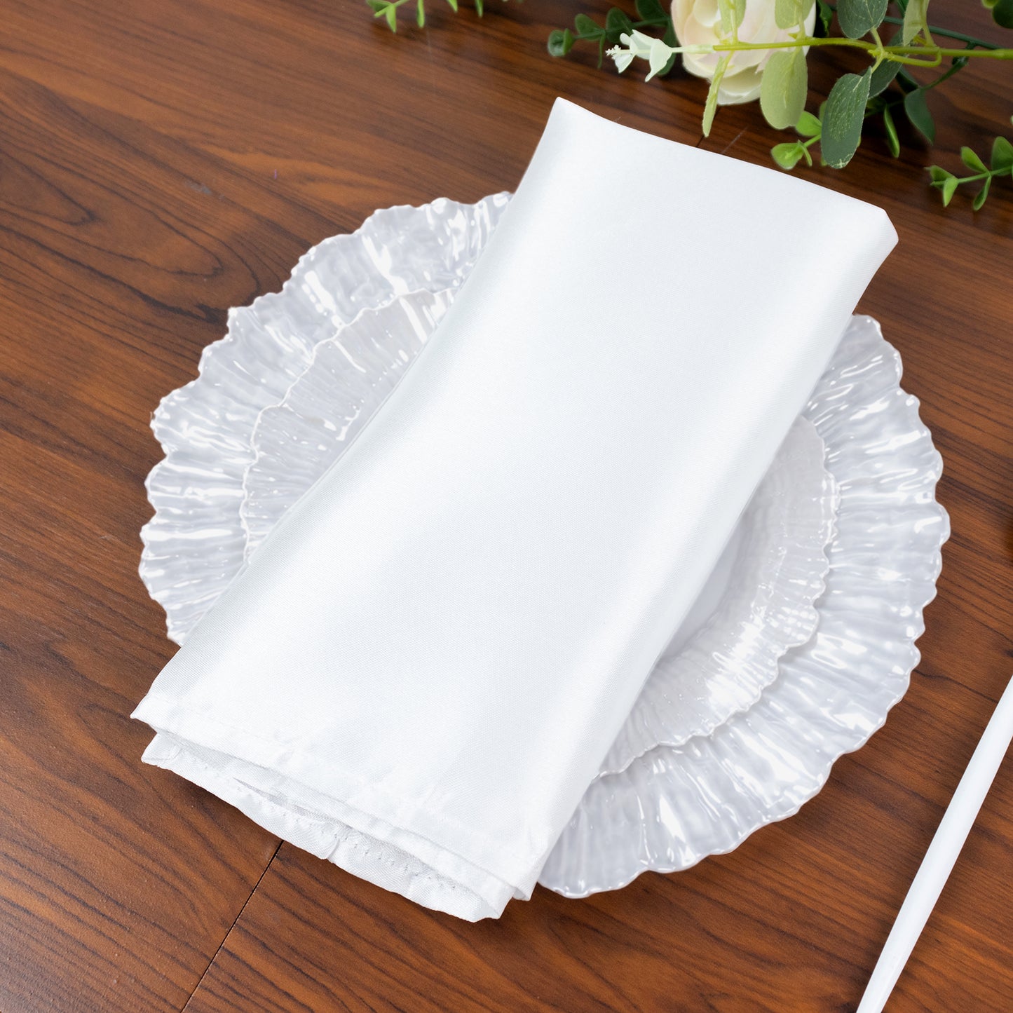 Pearl white dinner plate with elegant reef design on a wooden table.