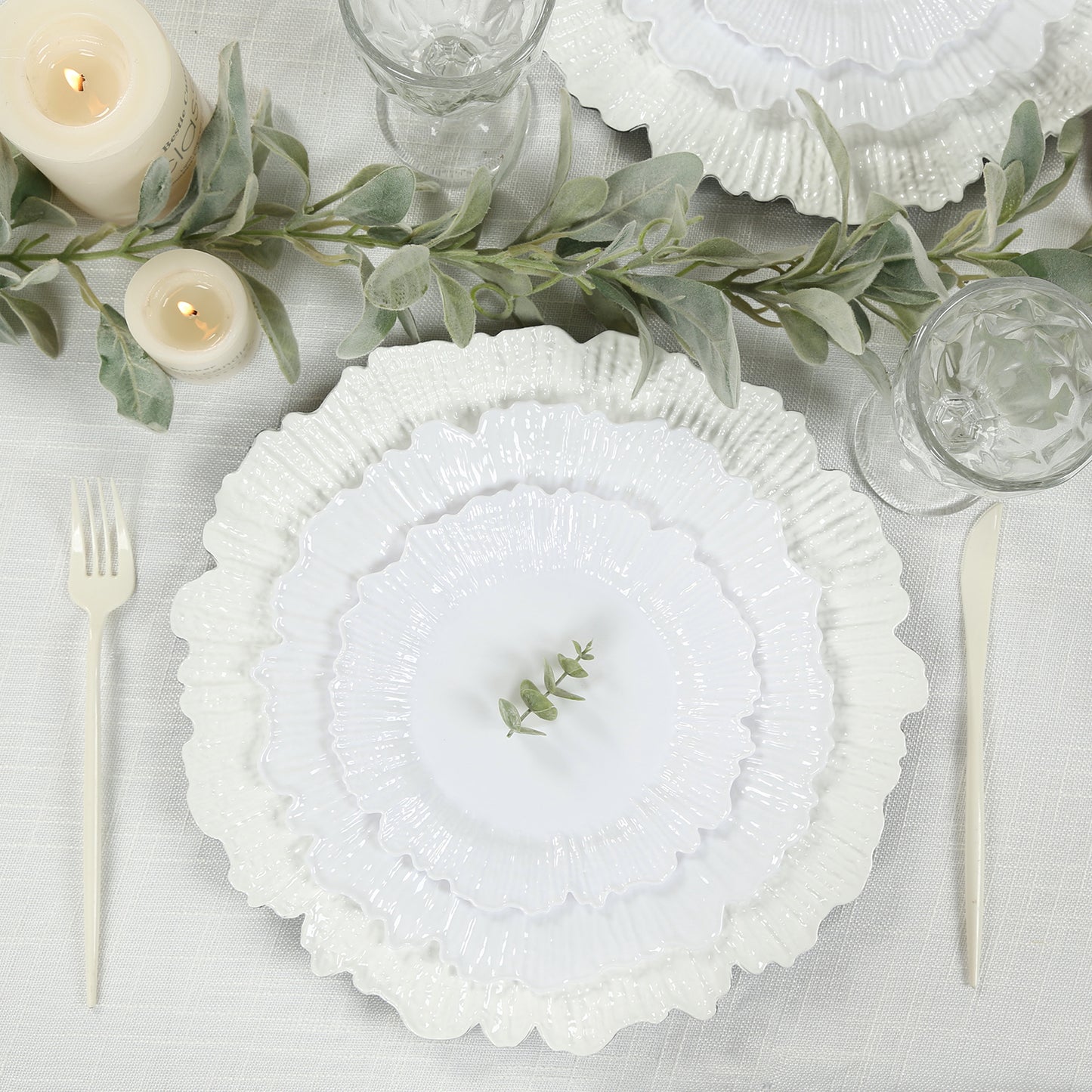 White reef design disposable dinner plates on a table setting.