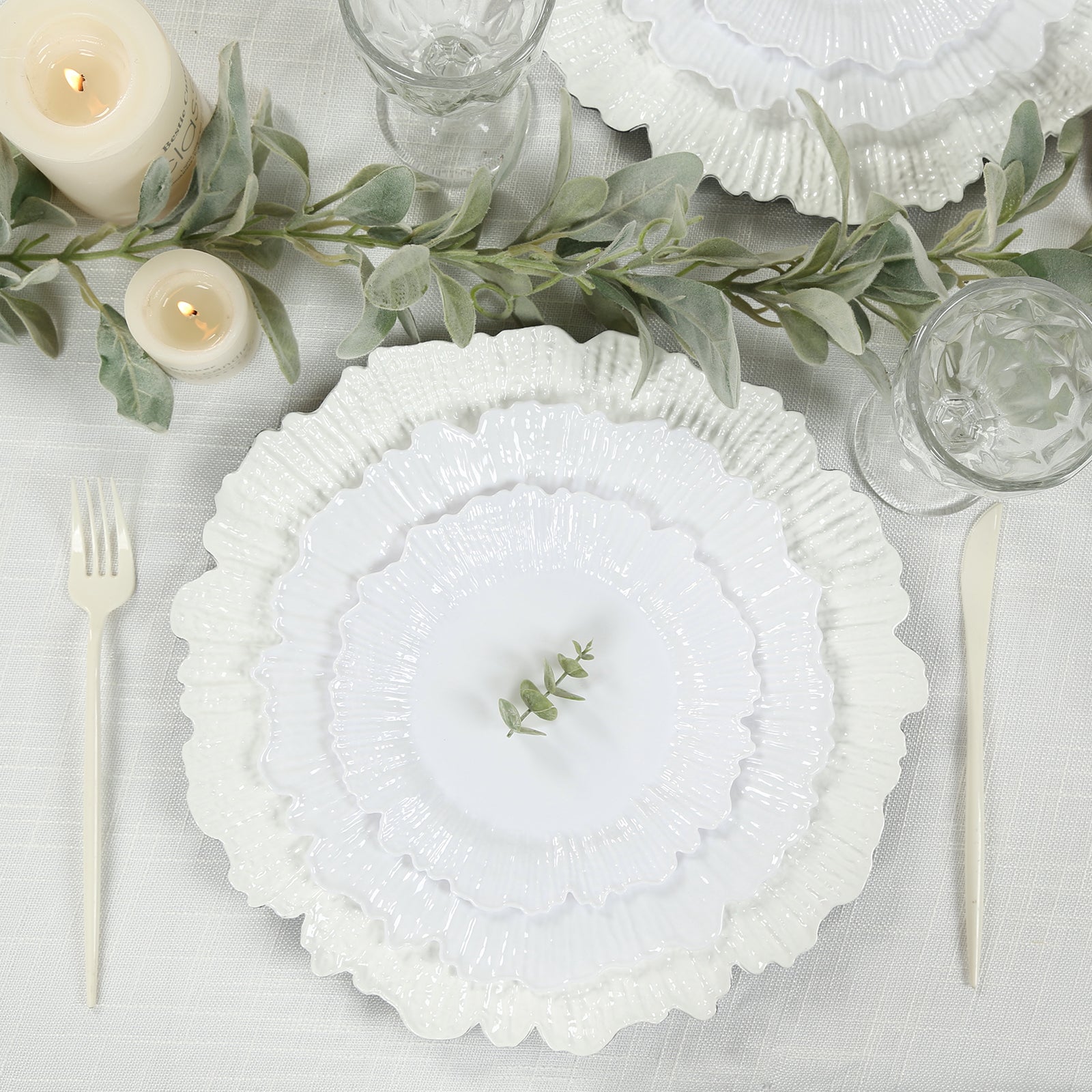 White reef design disposable dinner plates on a table setting.