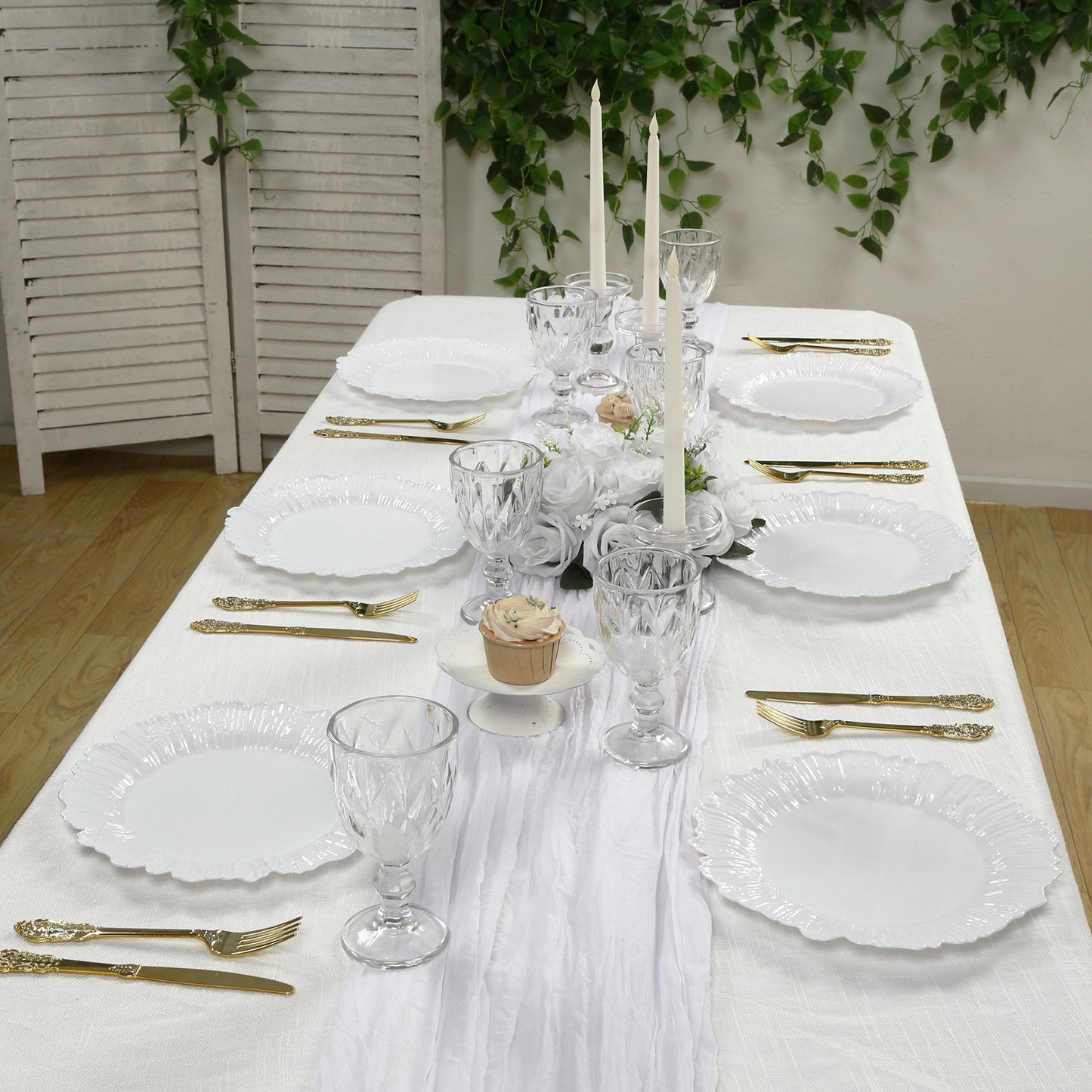 White plastic dinner plates with elegant reef design on a beautifully set table.