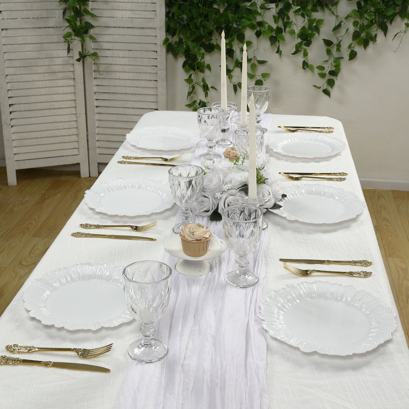 White plastic dinner plates with elegant reef design on a beautifully set table.