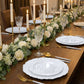 Pearl white dessert plates on an elegant dining table setting.