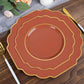 Rust terracotta dessert plates with gold rim on a wooden table.