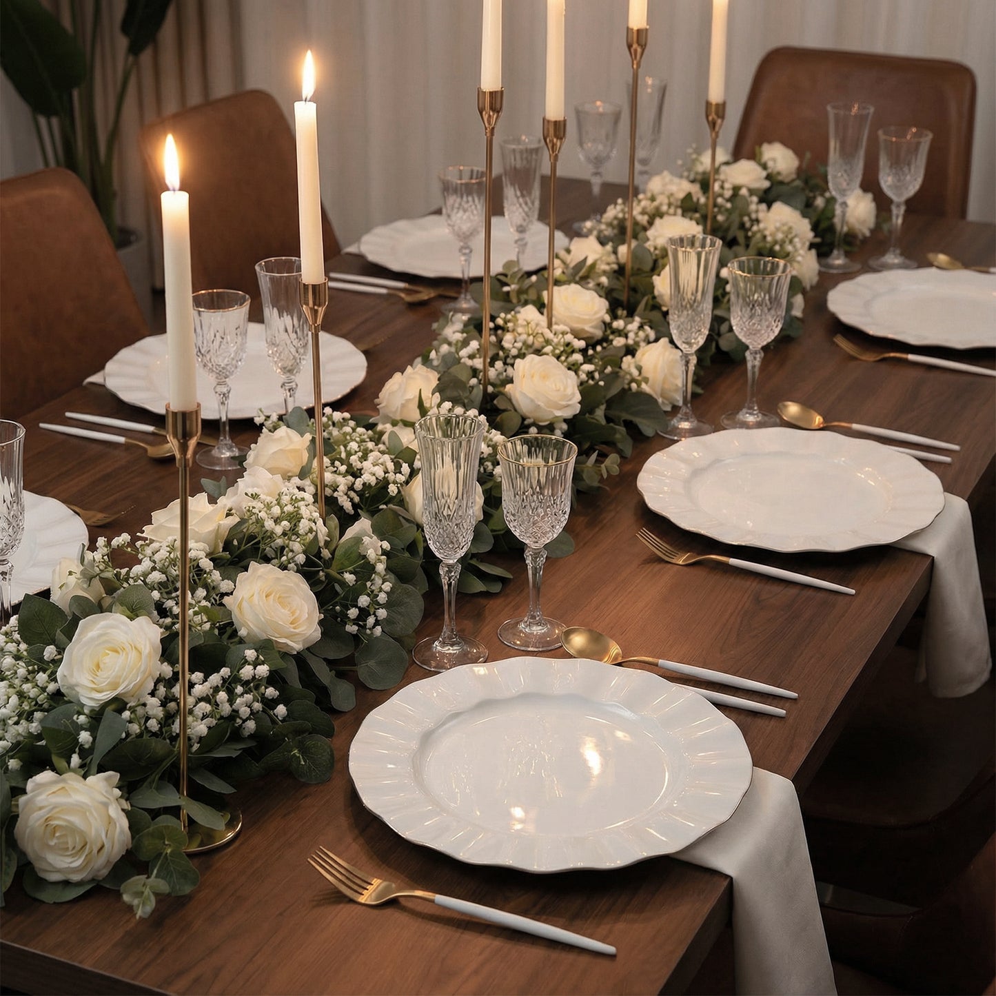 Pearl white ruffled rim dinner plates with gold edging on a decorated dining table.