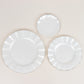 Pearl white ruffled rim dessert plates with gold edging.