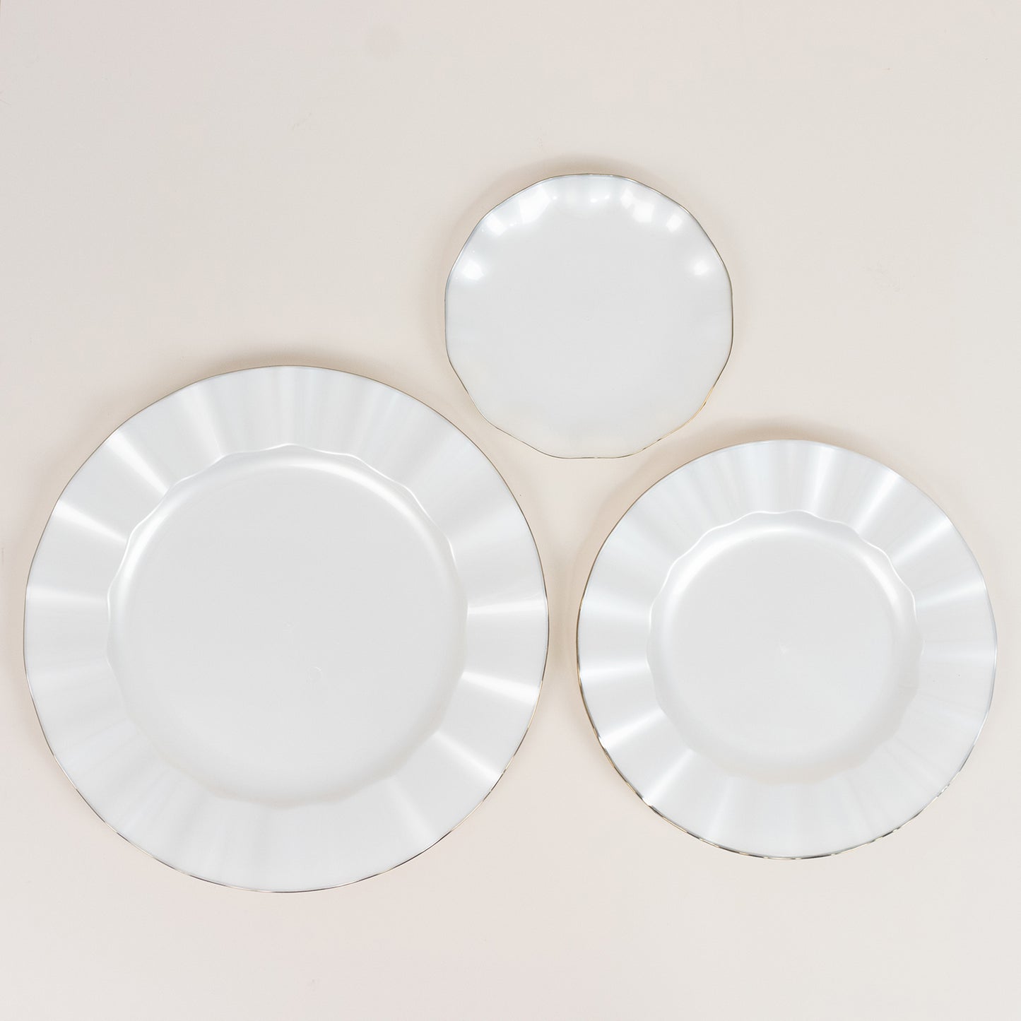 Pearl white ruffled rim dessert plates with gold edging.
