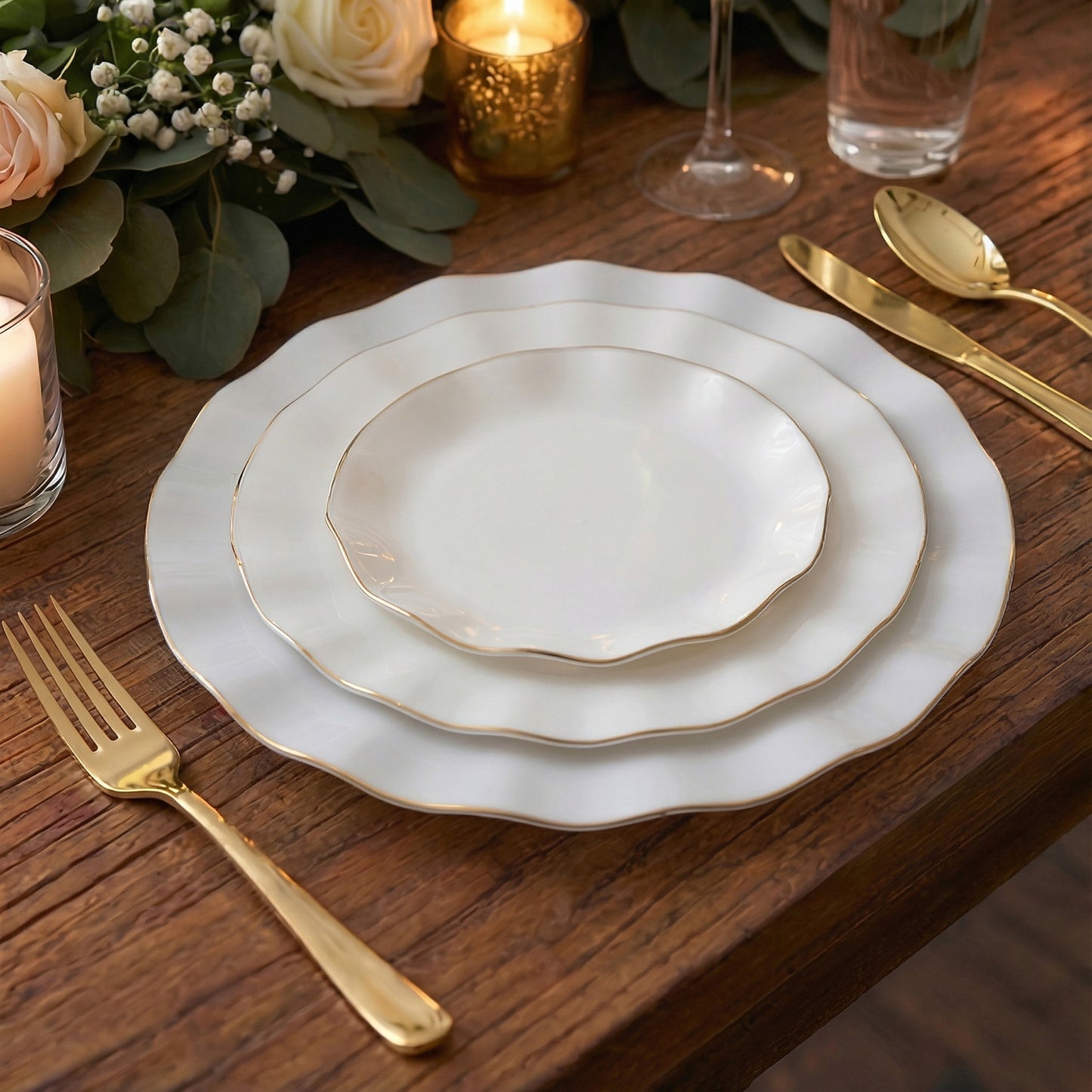 Pearl white ruffled rim dessert plates with gold edging on a wooden table.