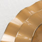 Gold disposable dinner plates with ruffled rim, perfect for any occasion.