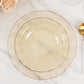 Gold glitter plastic dinner plate with ruffled rim on a marble surface.